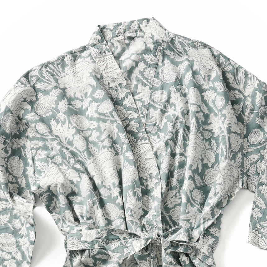 A long-sleeve wrap robe with a tie waist, featuring an all-over botanical block print pattern in sage green and white.