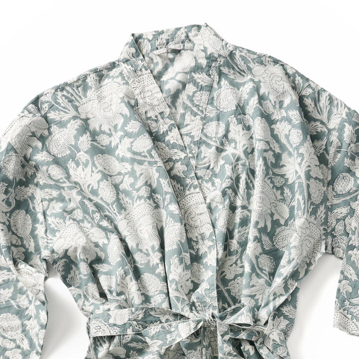 A long-sleeve wrap robe with a tie waist, featuring an all-over botanical block print pattern in sage green and white.