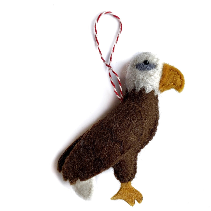 Felted eagle ornament with a string on a white background
