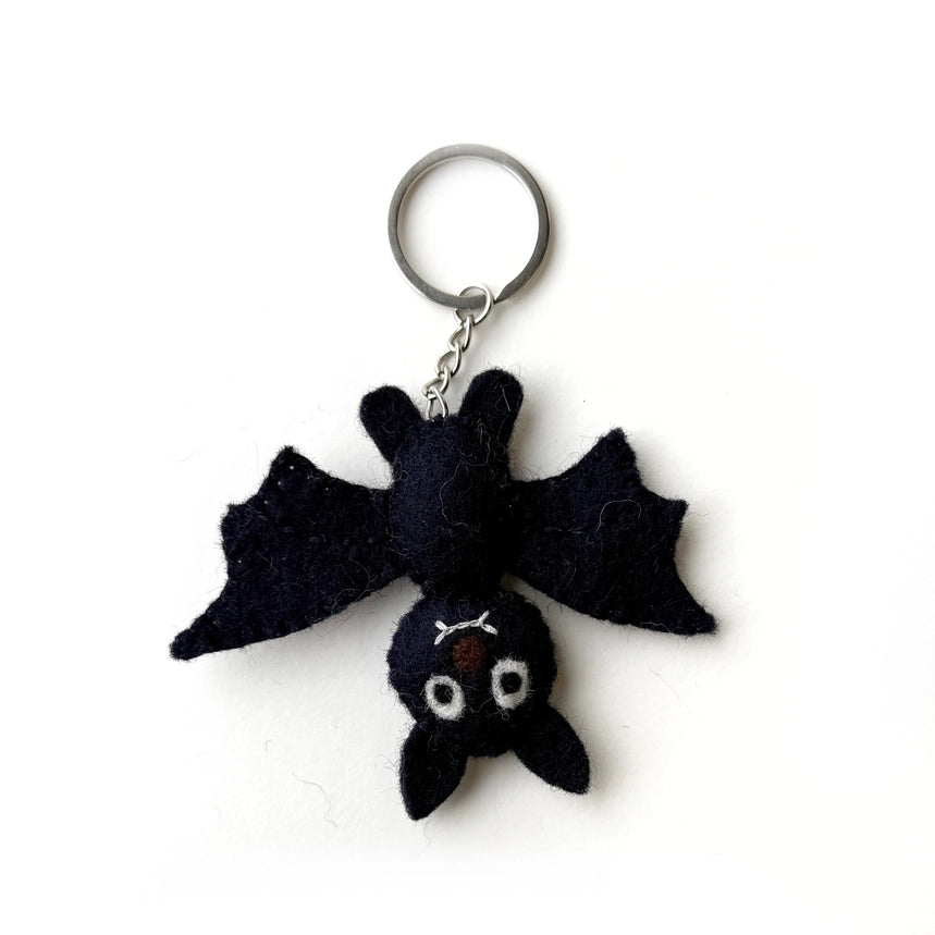 A black felt bat keychain with a silver metal split ring and chain, photographed on a plain white background.