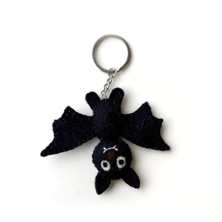 A black felt bat keychain with a silver metal split ring and chain, photographed on a plain white background.