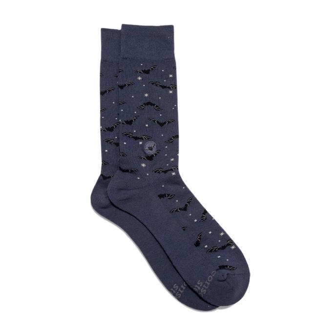 A pair of dark blue socks with a pattern of bats and stars.