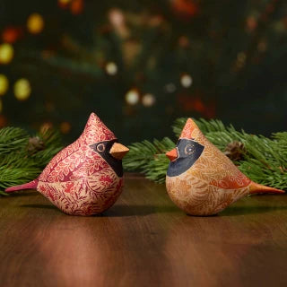 a batik male and female cardinal with branches in the background