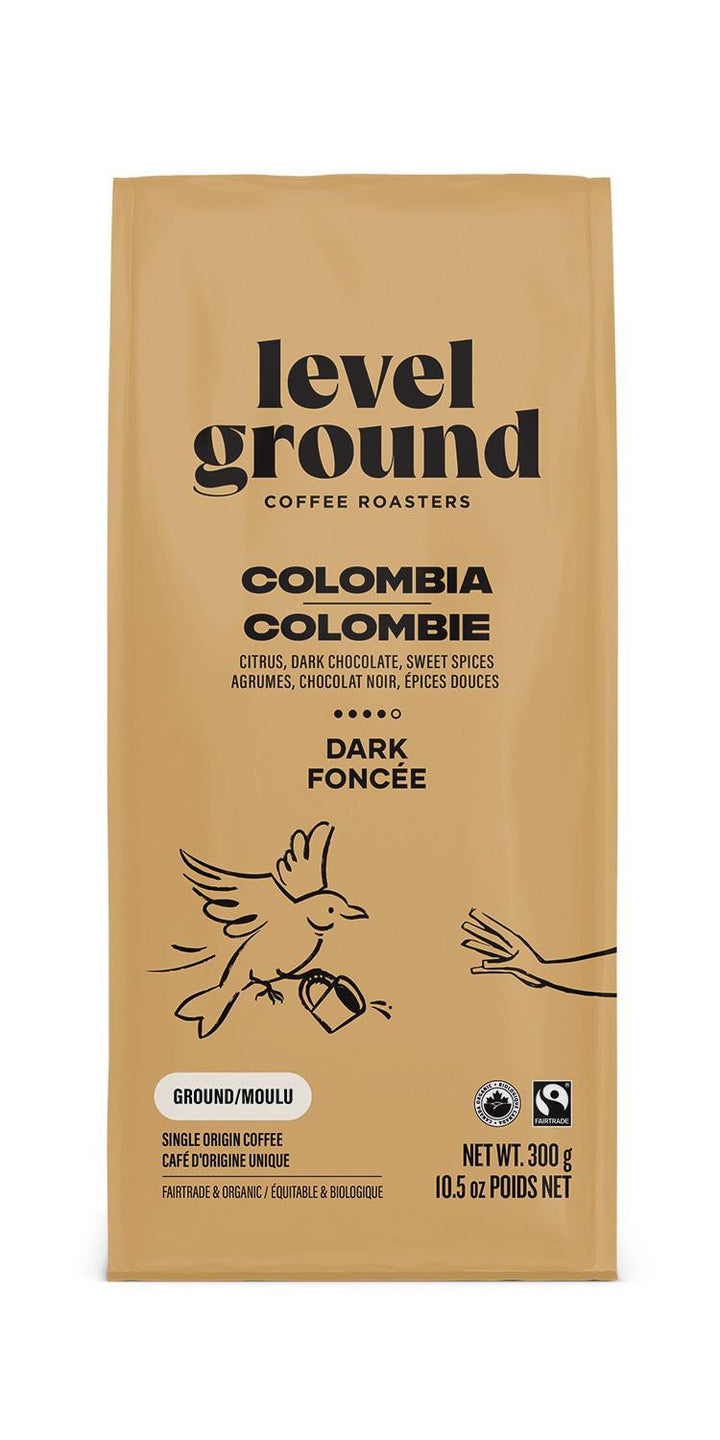 A bag of Level Ground Coffee Colombia with a graphic of a coffee bean and a bird on the front.