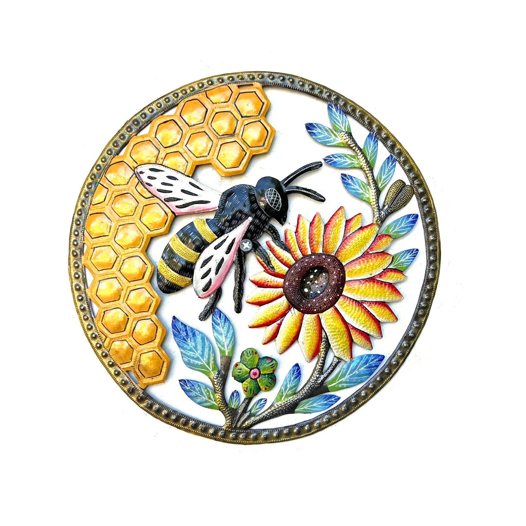 A round metal wall art featuring a detailed bee, a yellow sunflower, a honeycomb pattern, and blue leaves on a white background with a gold-toned beaded border.