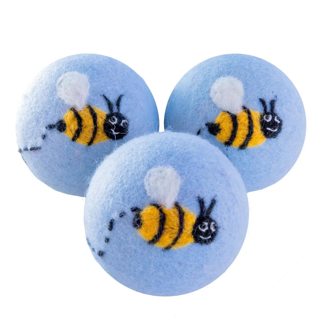 Three blue bee dryer balls on a white background