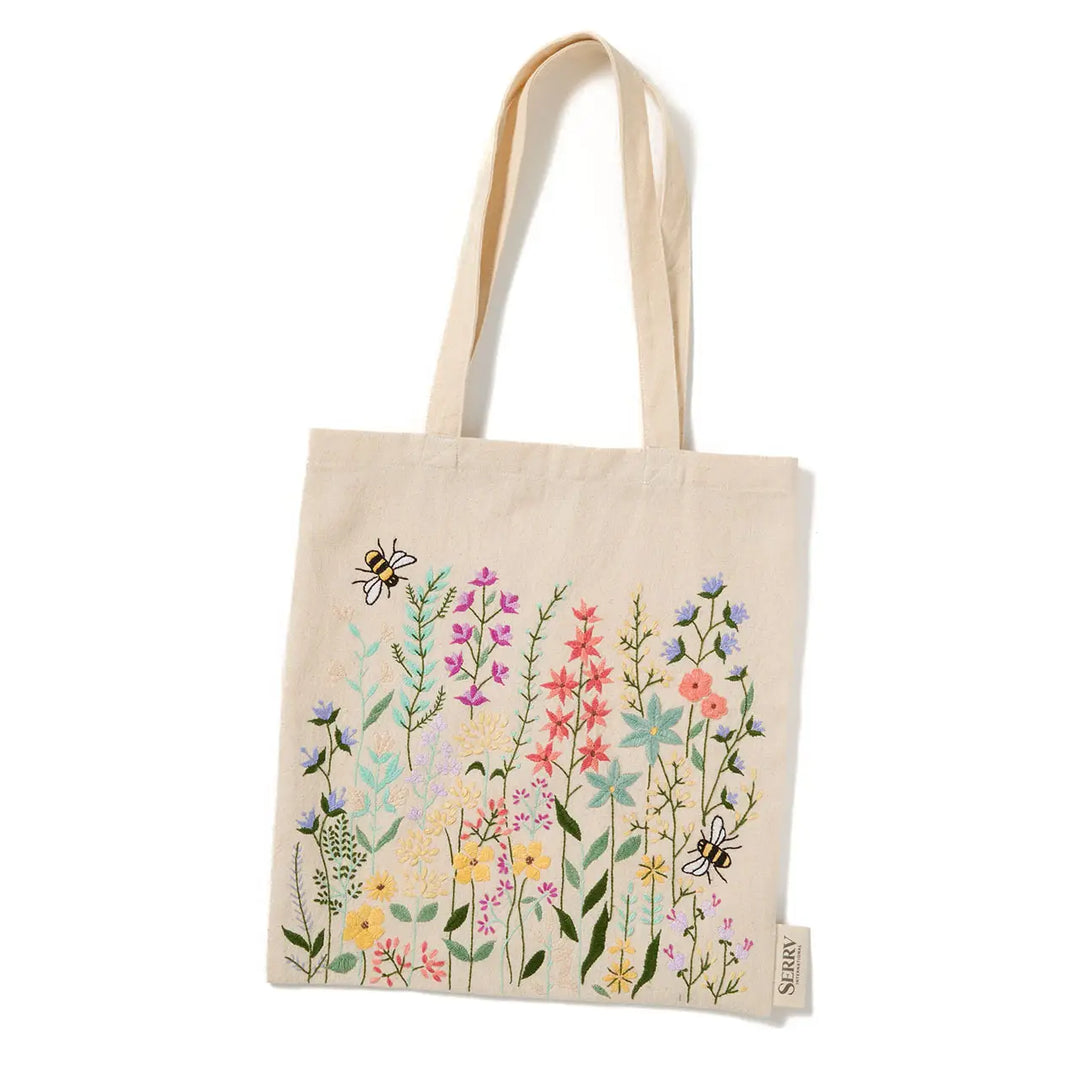 Tote bag with floral design and bee illustrations on a white background