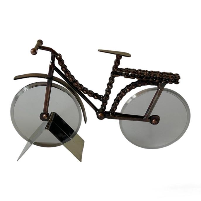 Hand made pizza cutter in the shape of a bike with chain links as the bike frame. 