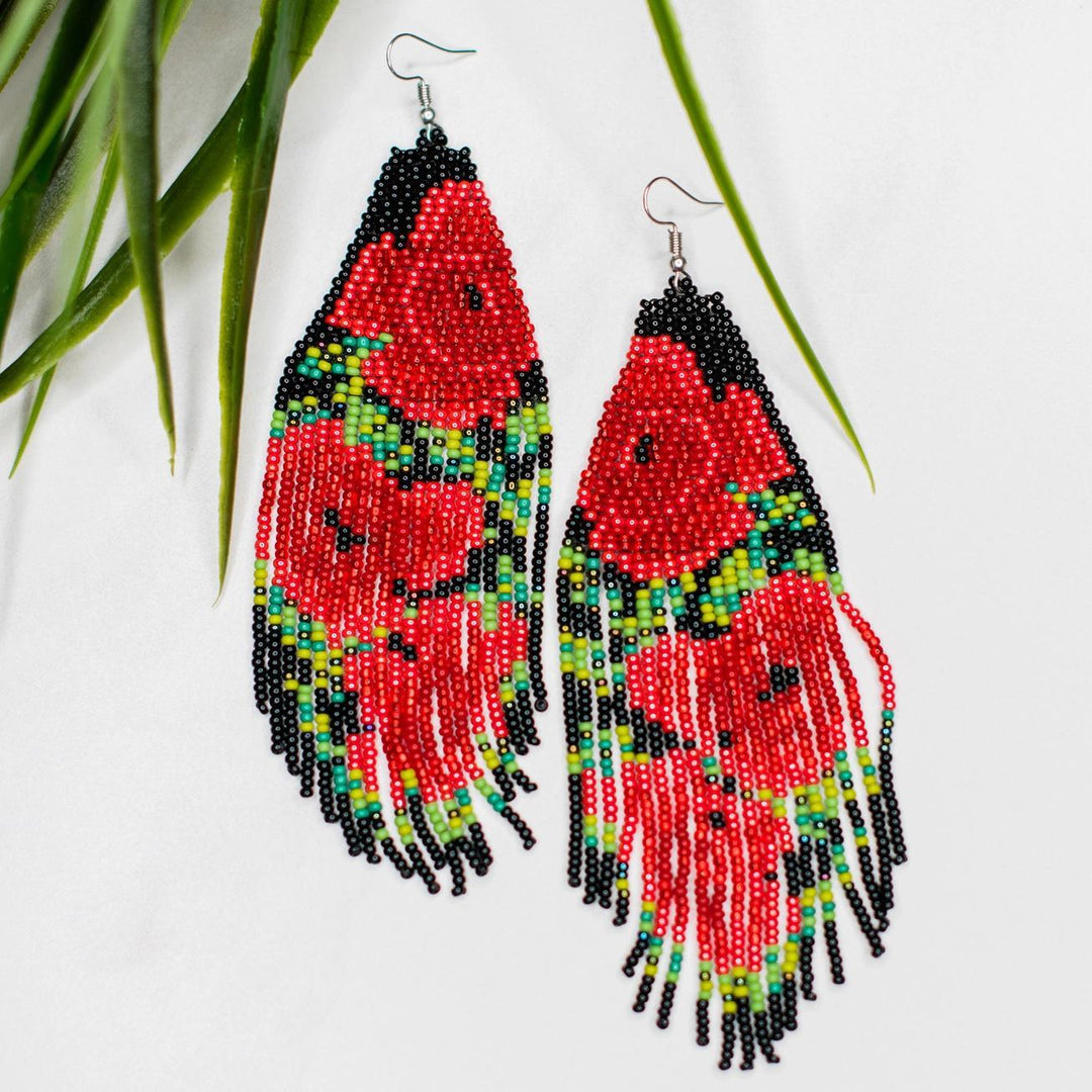 Colorful beaded earrings with fringes and a rose pattern on a white background