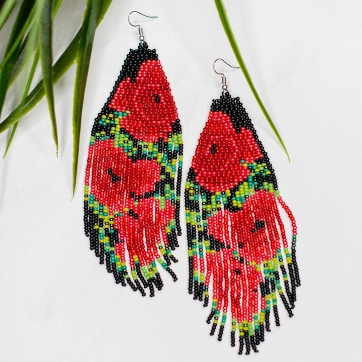 Colorful beaded earrings with fringes and a rose pattern on a white background