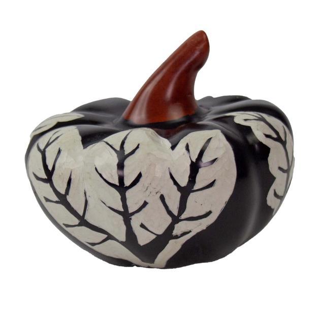 Ceramic black pumpkin with leaf design on a white background