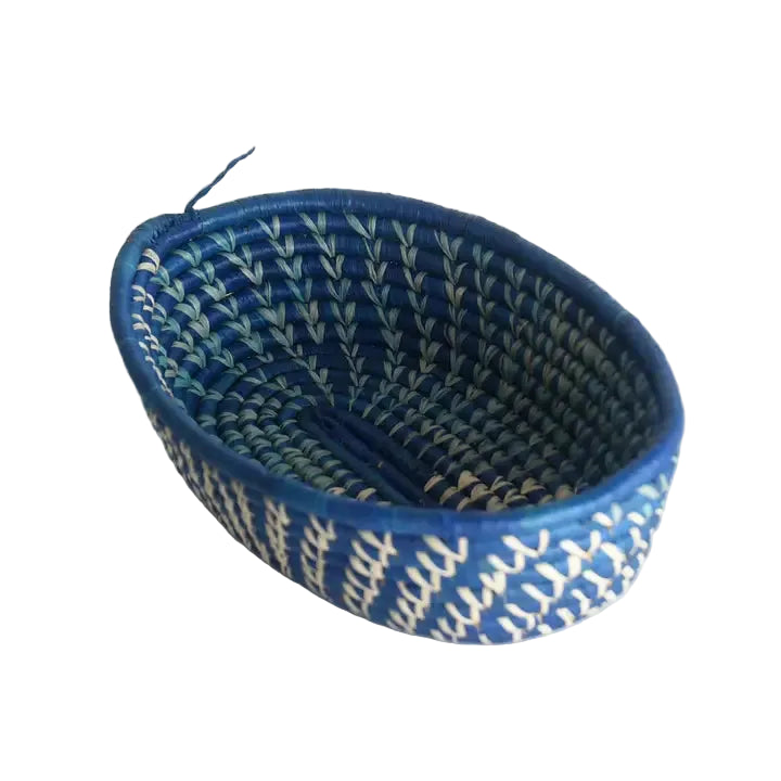 Blue woven basket with a white pattern on a light gray background