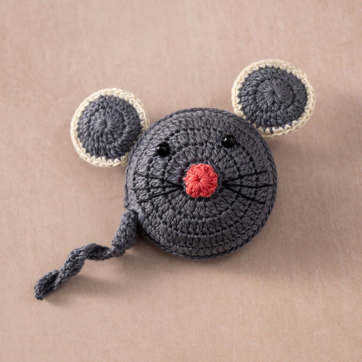 Crocheted mouse measuring tape on a beige background