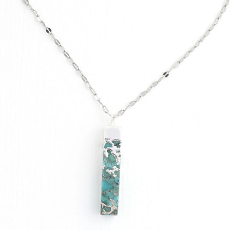 Necklace with a turquoise pendant on a white background