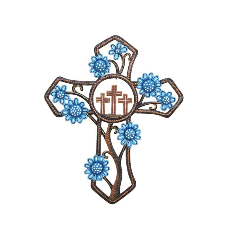 Decorative metal art cross with blue flowers on a white background