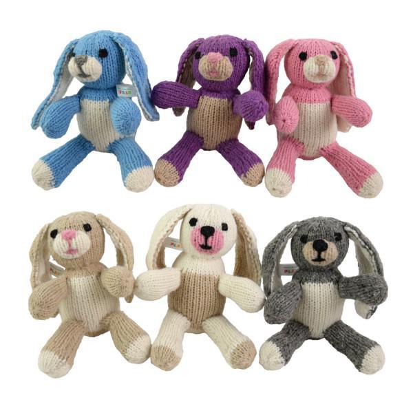 Six knitted bunny toys in different colors on a white background
