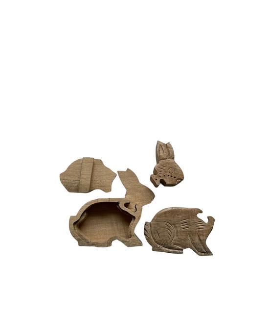 Handcrafted puzzle box in the shape of a bunny taken apart. 