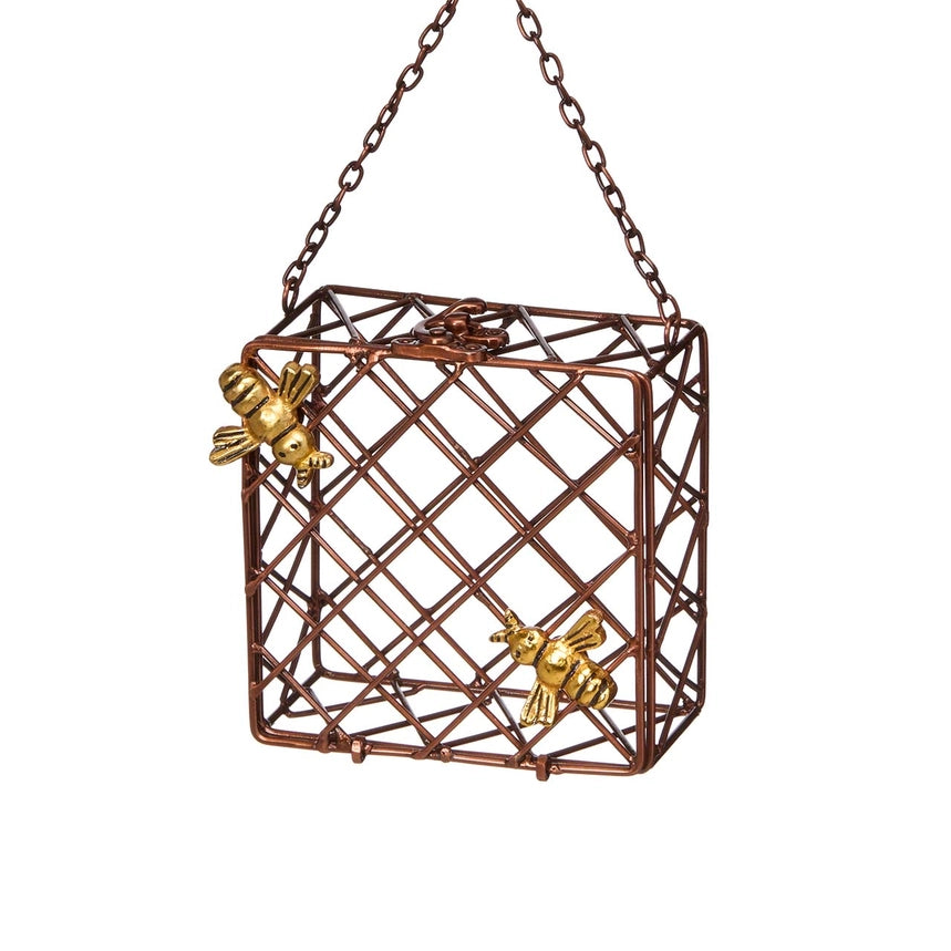 A hanging  suet bird feeder with bee detail against a plain white background.