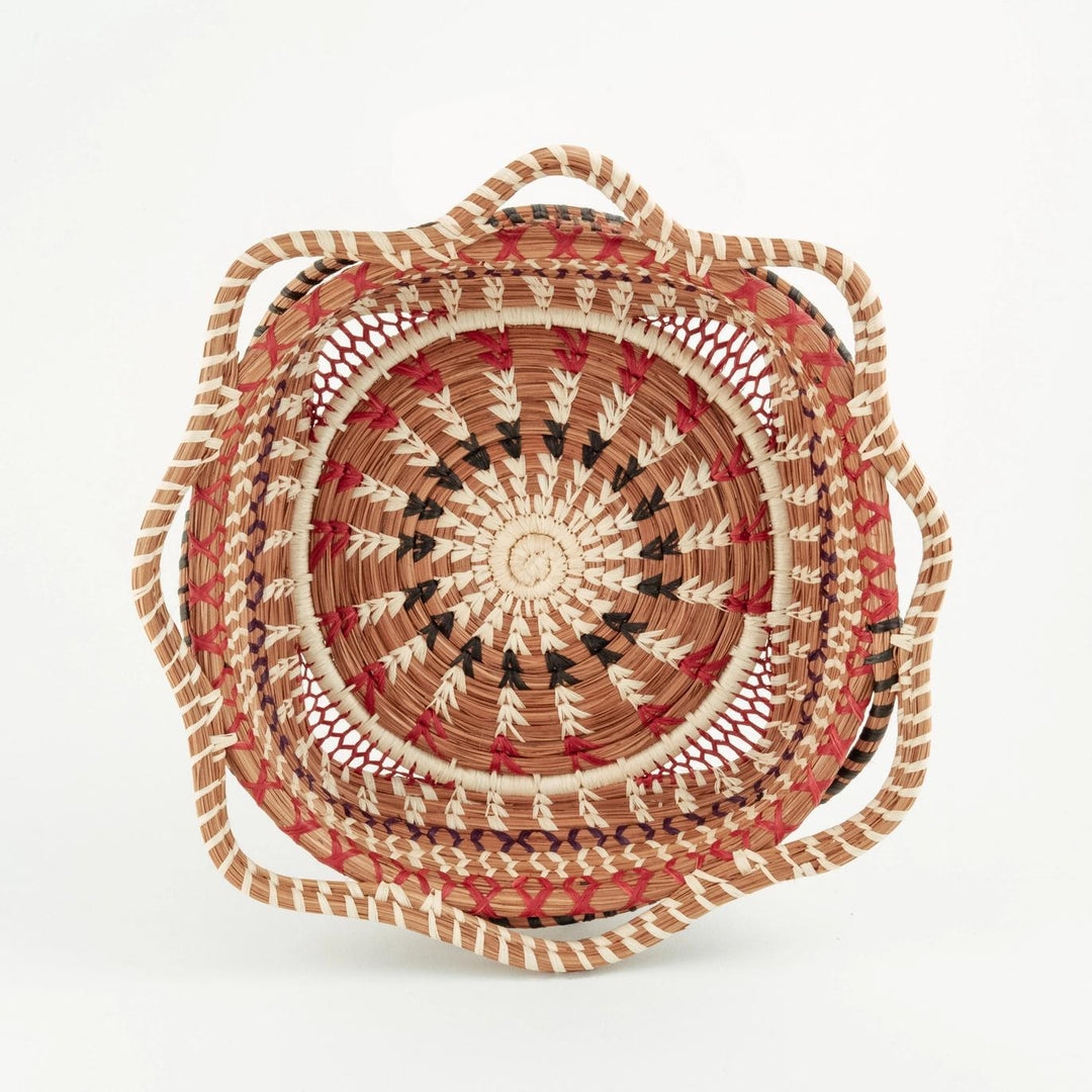 Woven basket with a circular design on a white background
