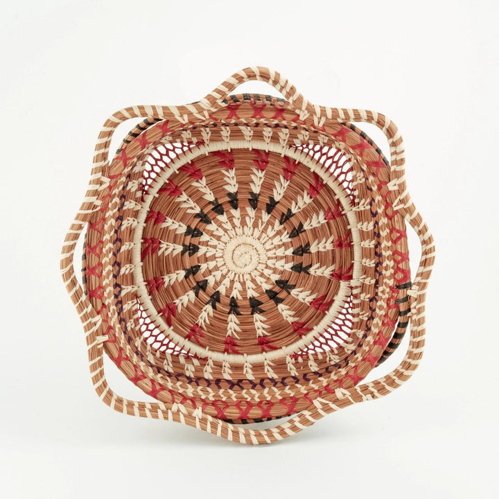 Woven basket with a circular design on a white background