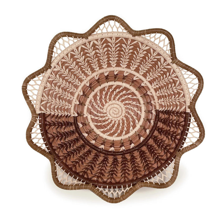 Decorative woven basket with intricate patterns on a white background