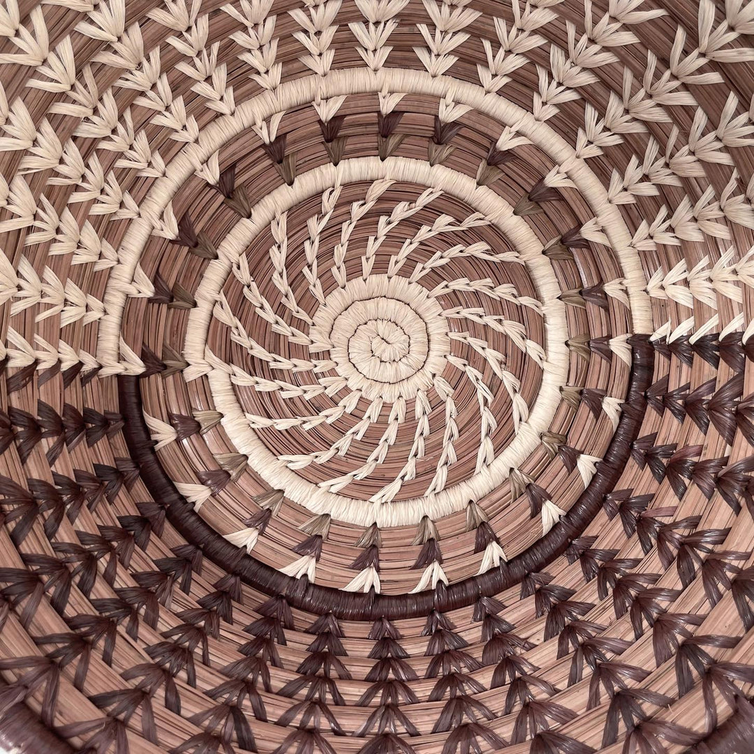 Close-up of a handmade woven basket with a spiral pattern
