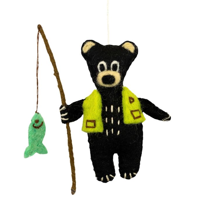 Felted black bear ornament with green vest and fishing rod on a white background