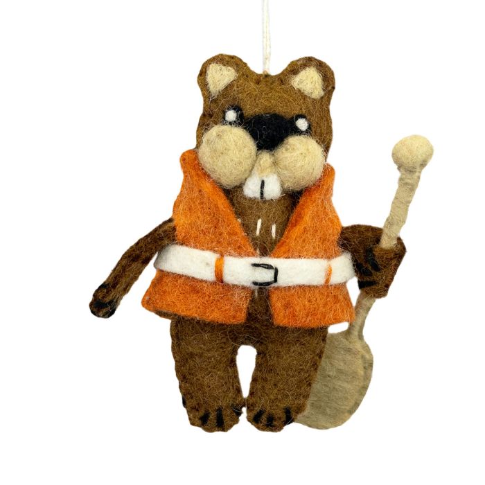 Felted animal ornament of a beaver wearing an orange vest and holding a paddle on a white background.