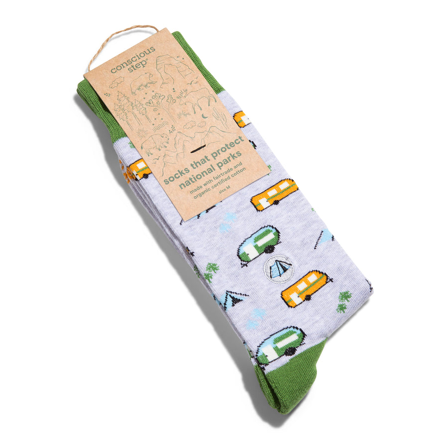 Socks with camping design and 'conscious step' packaging on a white background
