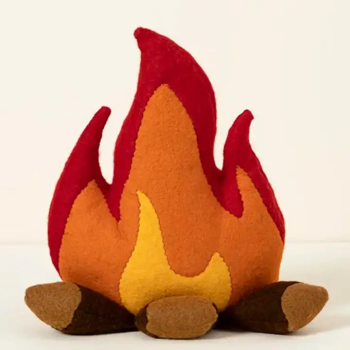 A felt campfire-shaped plush pillow with red, orange, yellow, and brown layers, photographed against a plain off-white background.