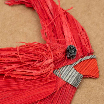 Red cardinal bird on a brown background
