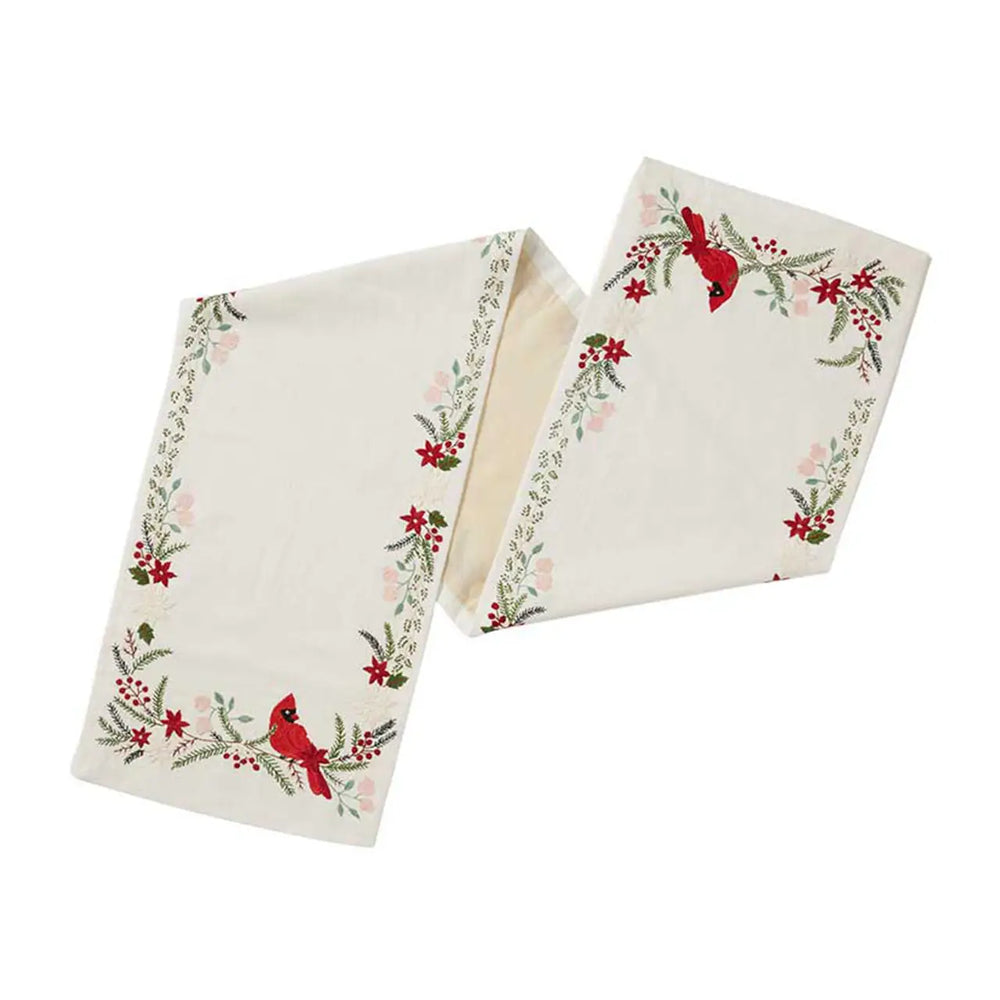 a table runner with cardinals and woodland greenery on a white background