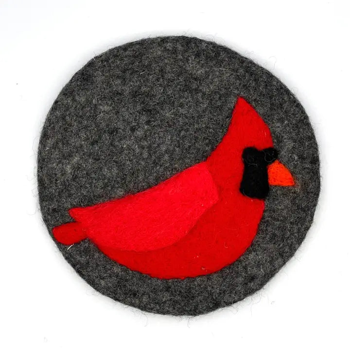Red cardinal bird on a gray circular trivet 
