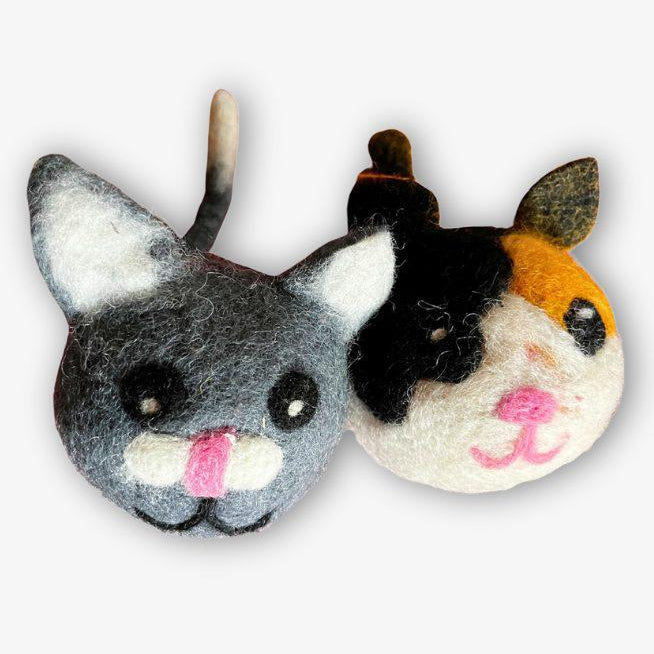 Two cat dryer balls on a white background 