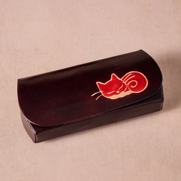Black case with red cat design on a beige background