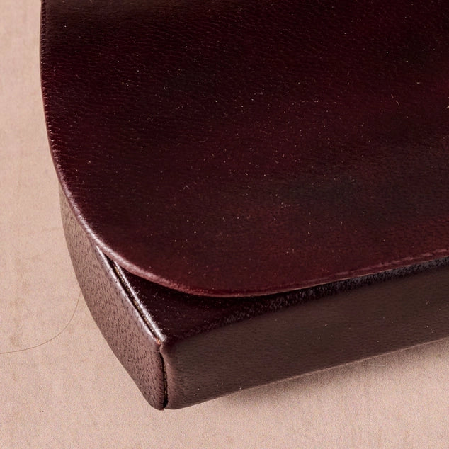 Close-up of a black leather product on a beige background
