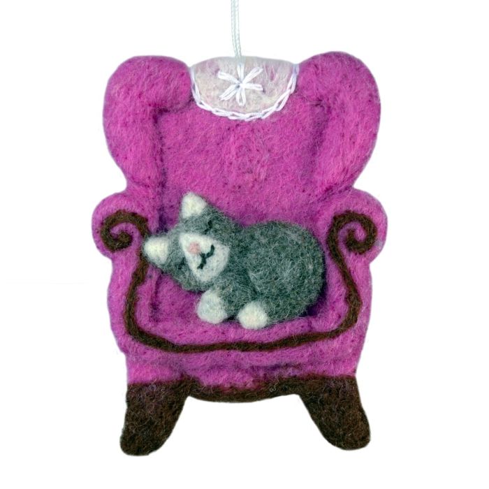 Felted ornament of a gray cat on a pink chair with a white background