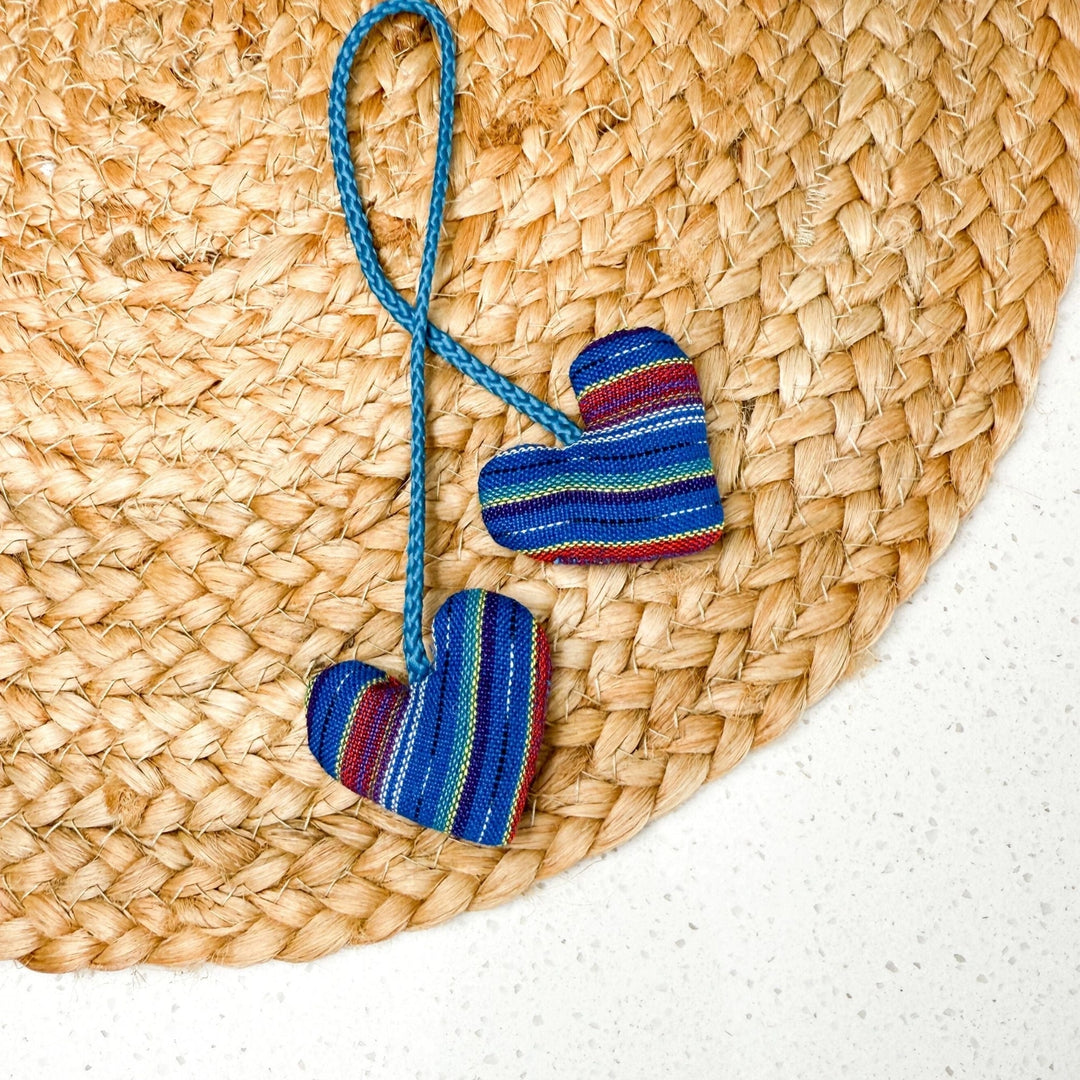 Colorful striped heart-shaped catnip on a woven mat