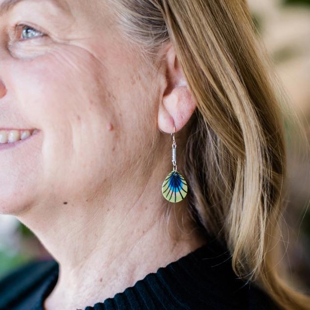 Painted ceramic earrings on a woman 