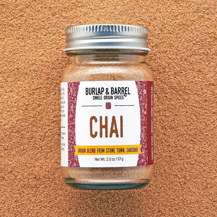 Jar of Burlap & Barrel Chai spice blend on a brown background