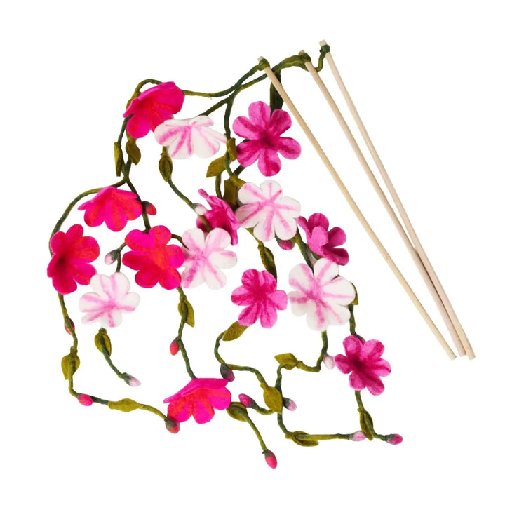 Floral cat teasers with pink and white flowers and wooden sticks on a white background