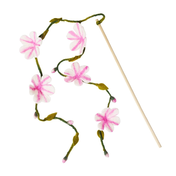 Floral cat teaser with pink flowers and a wooden stick on a white background