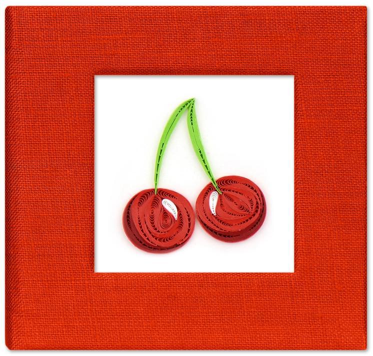 Red paper cherries with green stems on sticky note cover