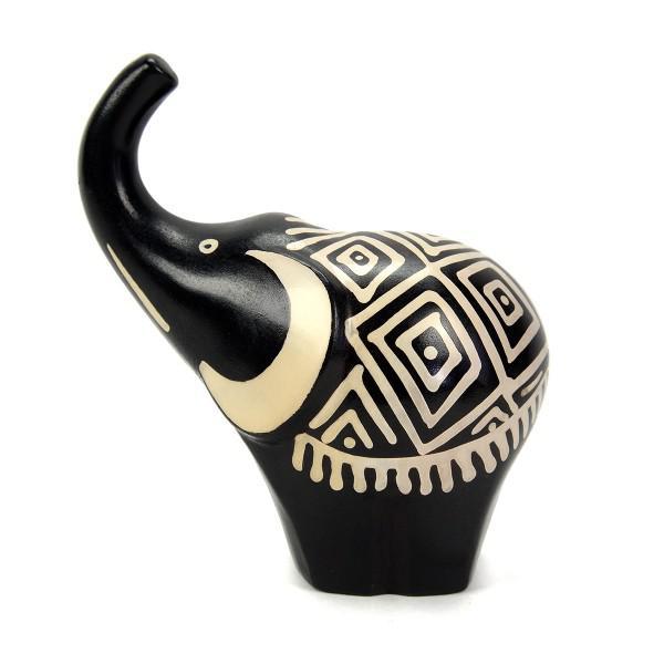 A small ceramic elephant figurine with predominantly black color and white geometric patterns.