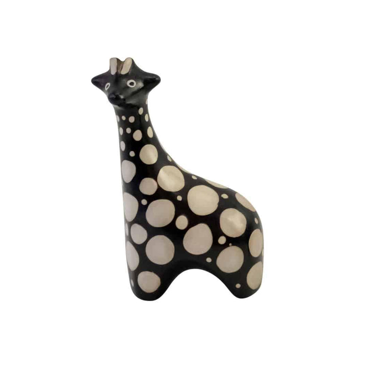 A ceramic giraffe-shaped sculpture with a black and white polka dot pattern.