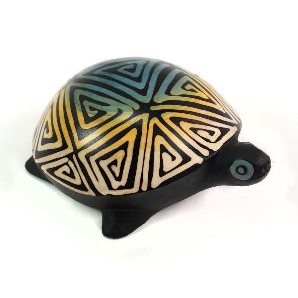 Decorative turtle figurine with geometric pattern on a white background