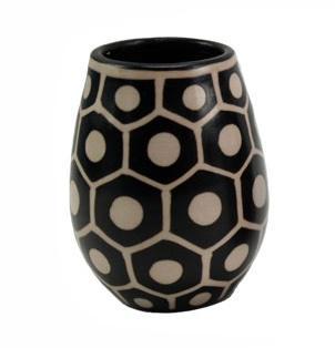 Ceramic vase with black and white geometric pattern on a white background