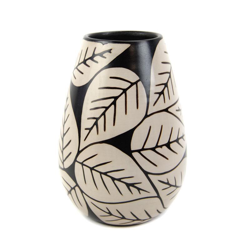 Ceramic vase with leaf pattern on a white background