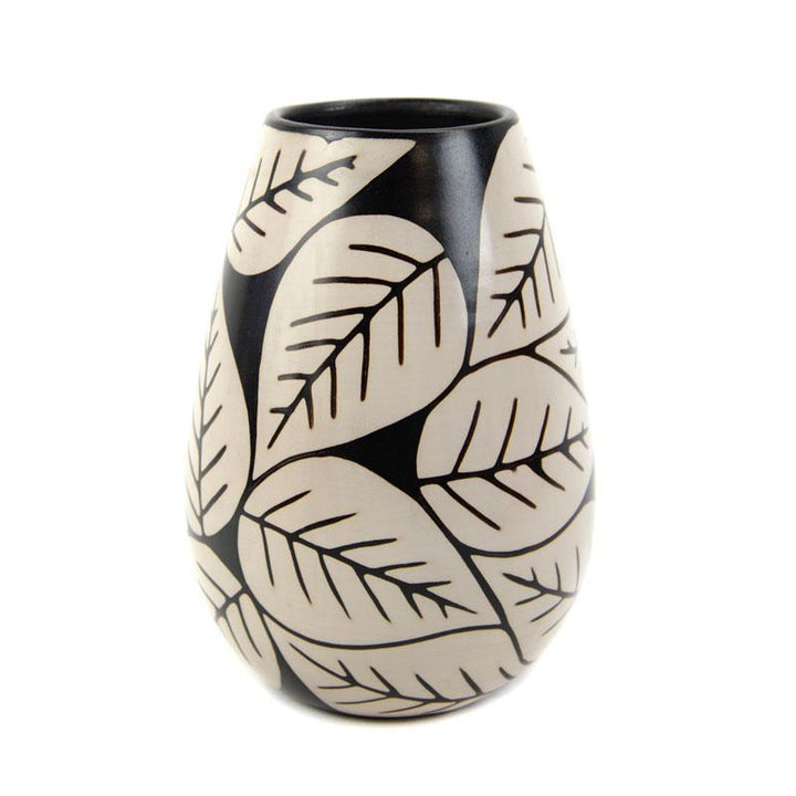 Ceramic vase with leaf pattern on a white background