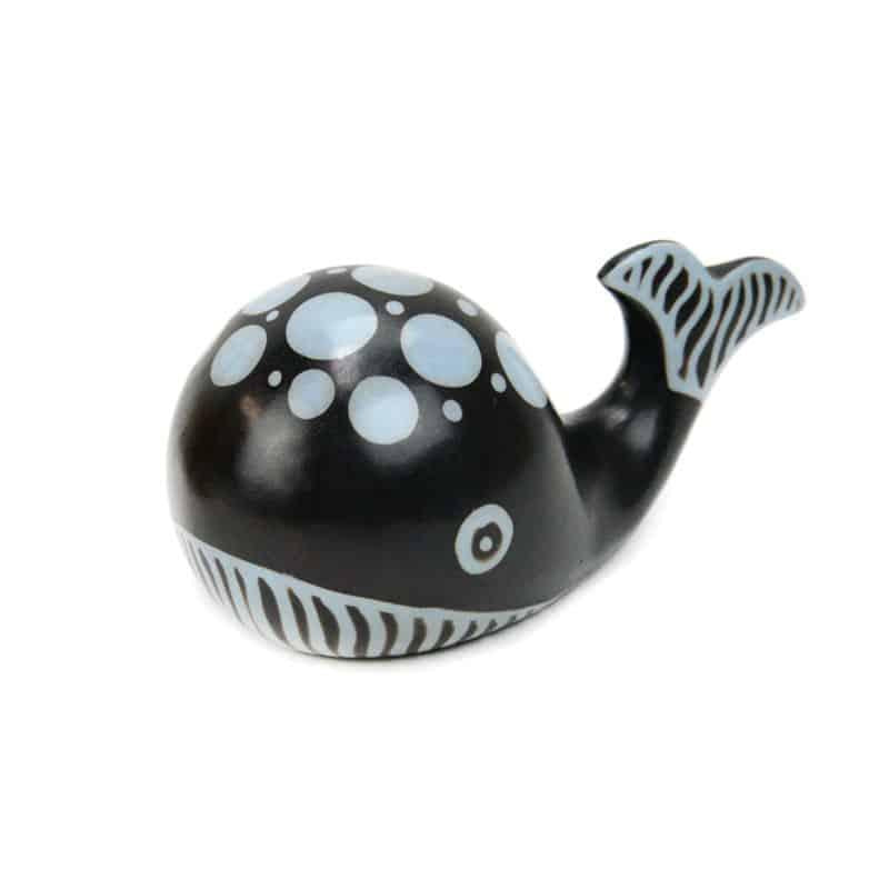A ceramic sculpture of a whale with black and white colors, featuring patterns and designs on its surface.